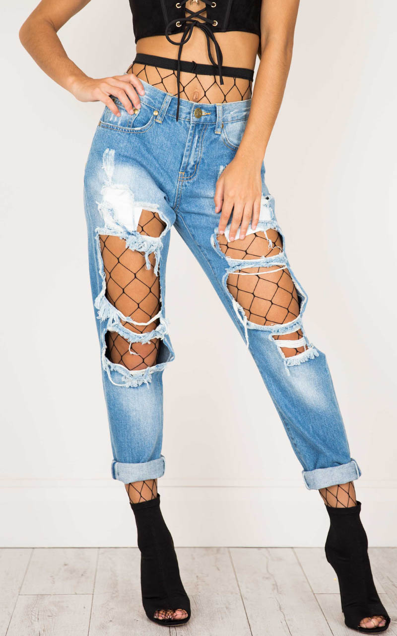 ripped jeans with fishnet tights